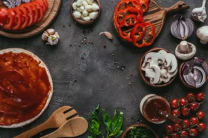 Backgroung-02top-view-of-various-pizza-ingredients-on-concrete-2024-11-17-09-45-35-utc-1.webp